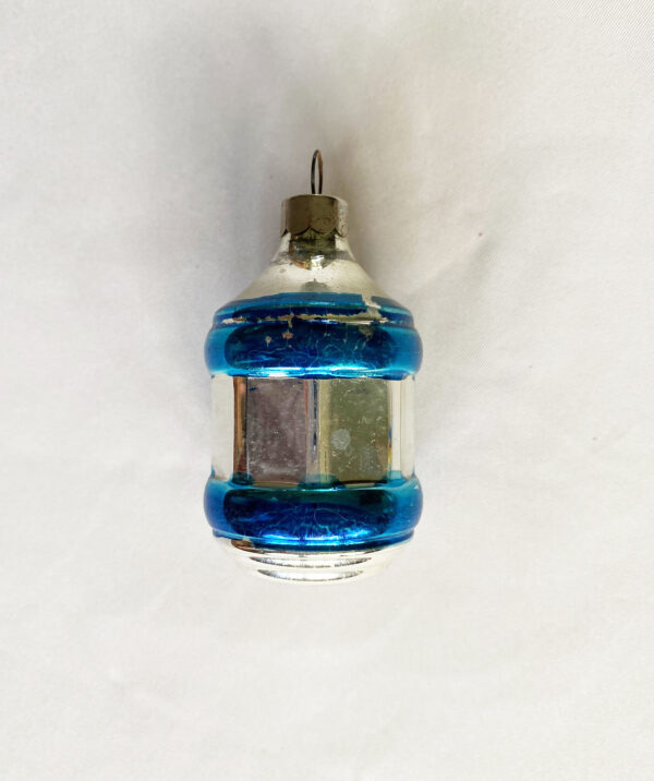 vintage 1940s war era Corning glass Christmas ornament in a barrel shape painted silver and blue. Retains the original metal cap with U S of A printed on the rim which helps to date this piece. Excellent condition free of chips or cracks with minimum paint loss. Wonderful USA ornament.