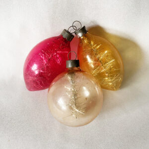 Three Corning 1940s War Era unsilvered glass Christmas ornaments with tinsel inside, two teadrops with color and one clear sphere, excellent.