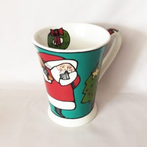Ursula Dodge retired Christmas coffee cup Santa and Sleeping Boy waiting for Santa ceramic Signature Housewares mug cup.