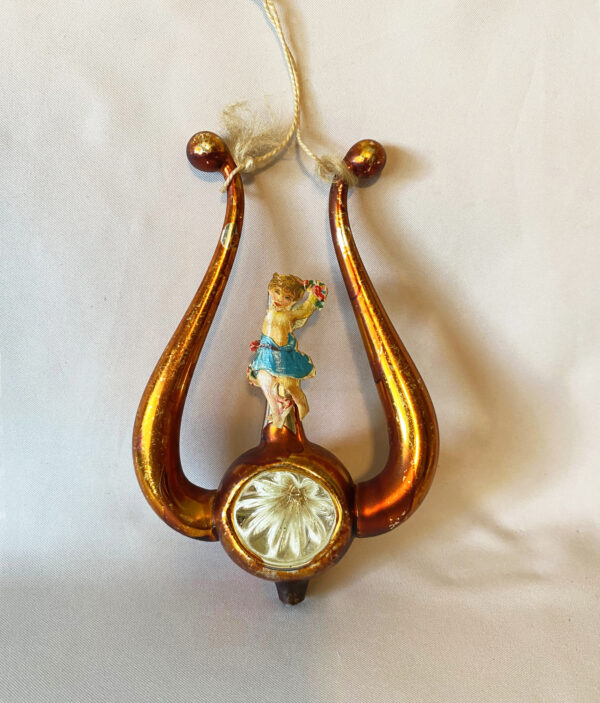 1900s German free blown lyre harp ornament with radial indent and scrap girl, copper colored with original cotton cord hanging loop, excellent
