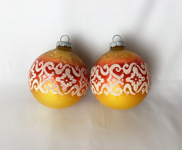 vintage pair of mid century orange Shiny Brite floral mica stencil ornaments with a graduating sunset color scheme, very good condition